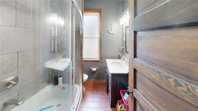 full bathroom featuring vanity, toilet, and tiled shower / bath combo