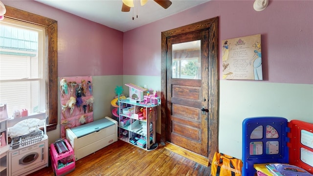 playroom featuring ceiling fan, plenty of natural light, and wood-type flooring