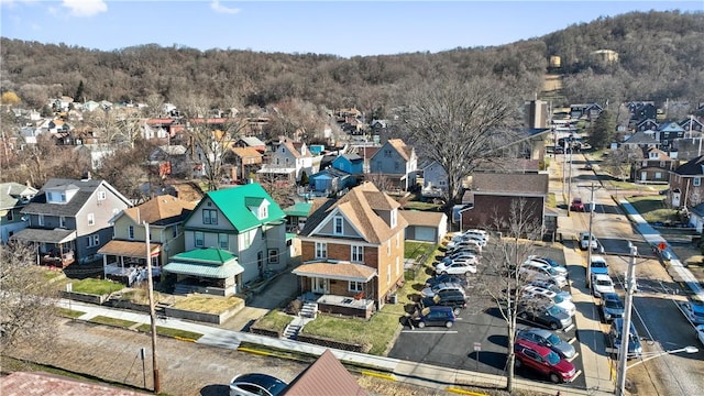aerial view with a wooded view and a residential view