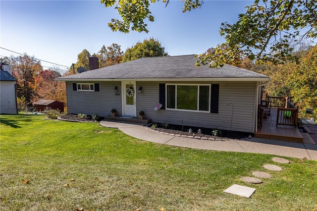 ranch-style house with a front lawn and a deck