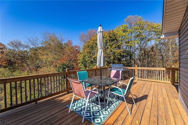 wooden deck featuring a grill