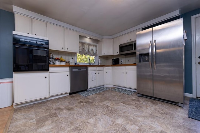 kitchen with decorative backsplash, appliances with stainless steel finishes, and white cabinetry