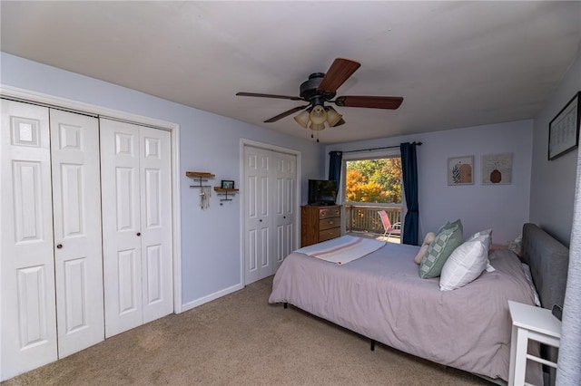 bedroom featuring carpet flooring, ceiling fan, and multiple closets