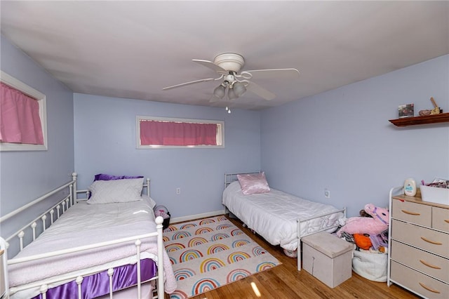 bedroom with ceiling fan and hardwood / wood-style flooring