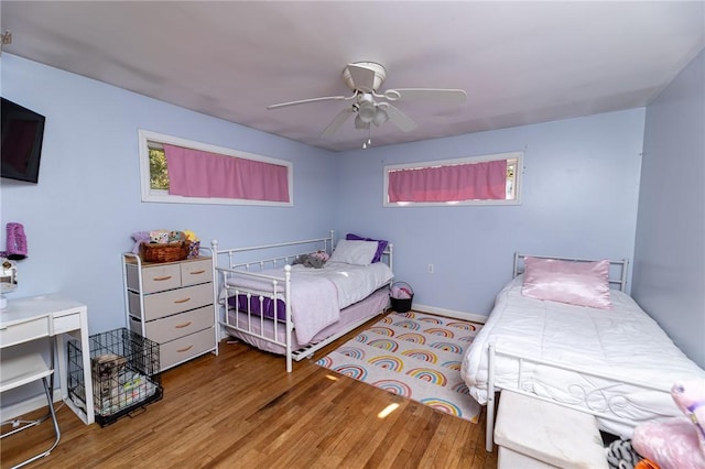 bedroom with ceiling fan and light hardwood / wood-style flooring