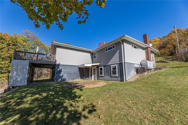 rear view of property with a lawn and a deck