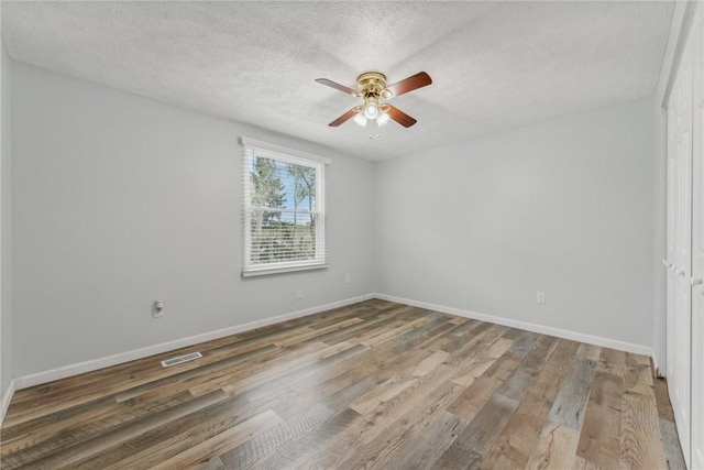 spare room featuring ceiling fan, a textured ceiling, and hardwood / wood-style flooring