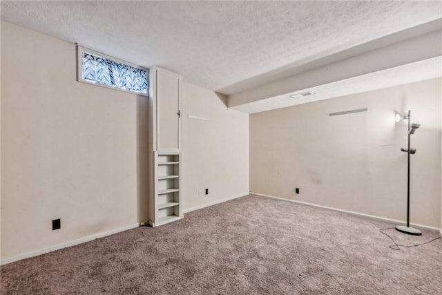 basement featuring carpet floors and a textured ceiling