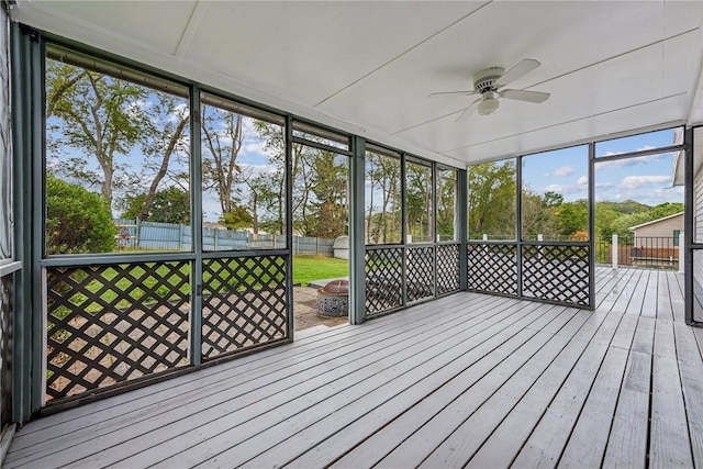 unfurnished sunroom featuring ceiling fan