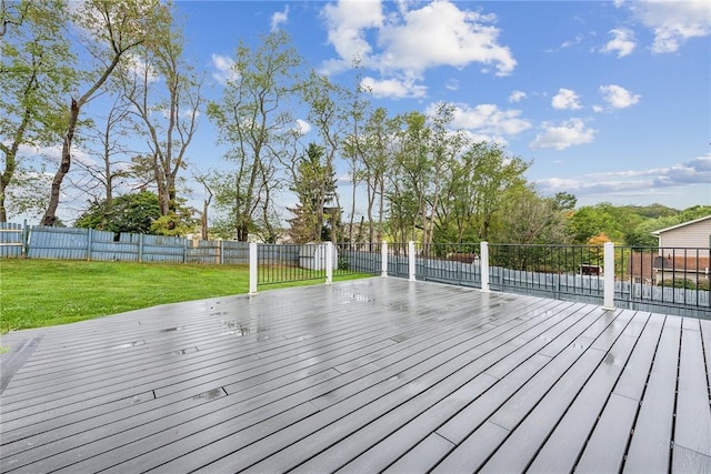 wooden deck featuring a lawn