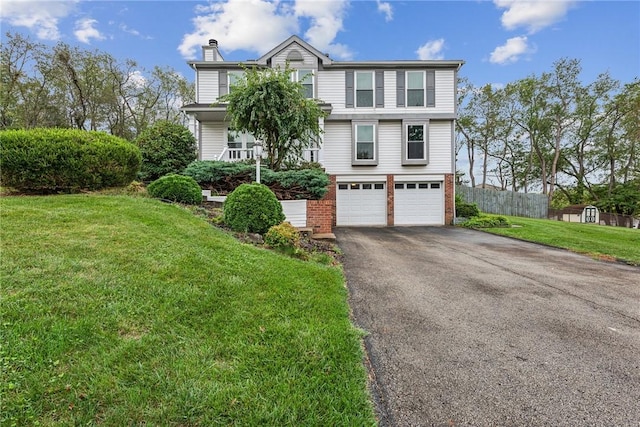 view of front of home with a front yard and a garage