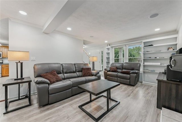 living room with beam ceiling, crown molding, and light hardwood / wood-style flooring