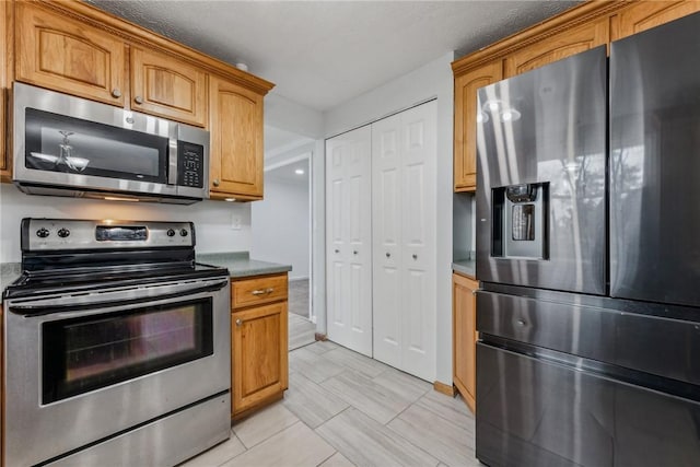 kitchen featuring light tile patterned floors and stainless steel appliances