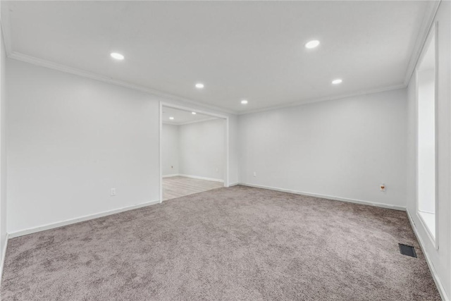 carpeted spare room featuring ornamental molding