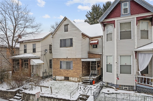 view of snow covered rear of property