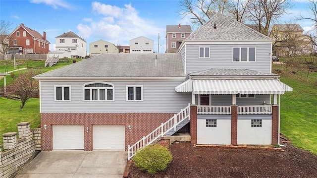 view of front of property featuring a garage and a front lawn