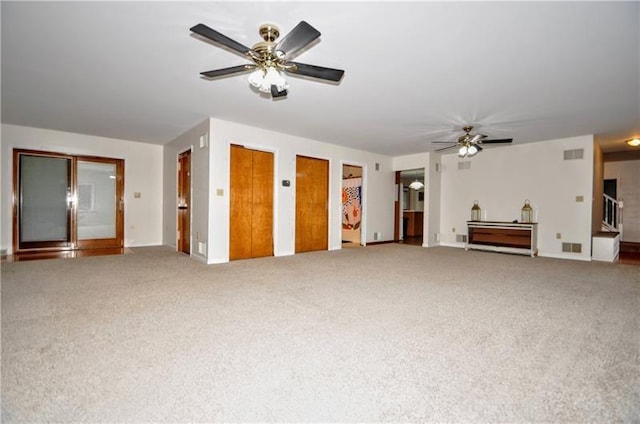 unfurnished living room featuring carpet flooring and ceiling fan