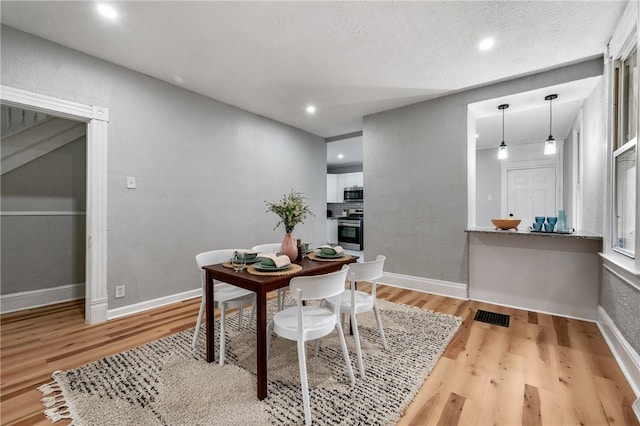 dining space featuring light hardwood / wood-style flooring