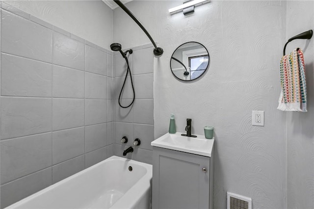 bathroom featuring vanity and tiled shower / bath combo