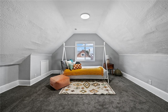 carpeted bedroom with a textured ceiling and lofted ceiling