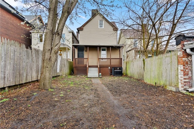 back of property with central AC