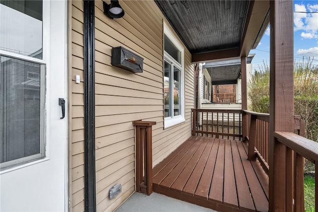 wooden terrace featuring covered porch