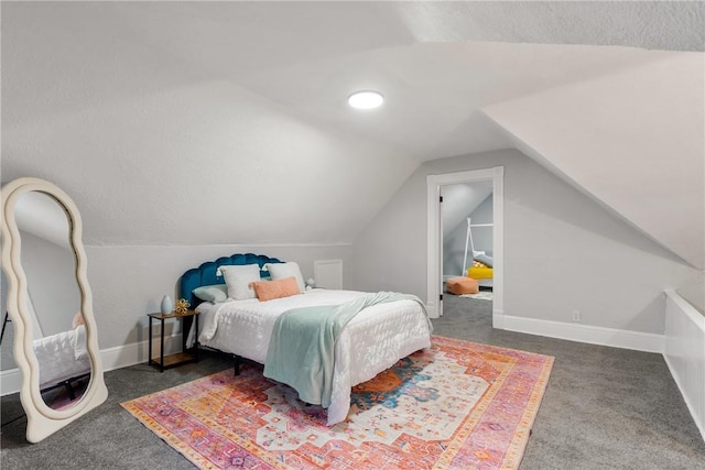 bedroom with dark carpet and lofted ceiling