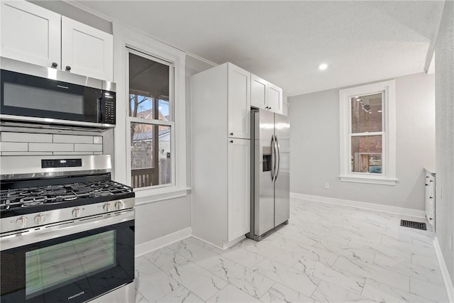 kitchen featuring white cabinets and appliances with stainless steel finishes