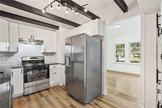 kitchen featuring appliances with stainless steel finishes, tasteful backsplash, track lighting, white cabinets, and light hardwood / wood-style floors