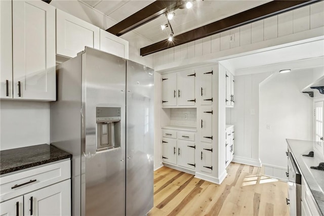 kitchen featuring stainless steel refrigerator with ice dispenser, backsplash, beam ceiling, light hardwood / wood-style flooring, and white cabinetry