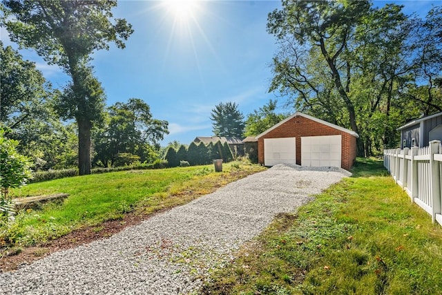 exterior space with a garage and an outbuilding