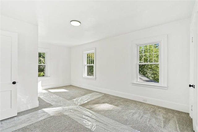 unfurnished room featuring light colored carpet