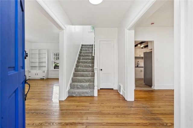 foyer featuring hardwood / wood-style floors and sink