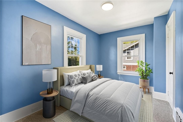 bedroom featuring carpet and baseboard heating