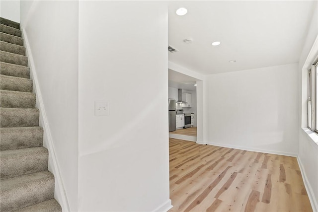 staircase with hardwood / wood-style floors