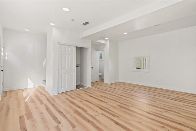 unfurnished room with light wood-type flooring