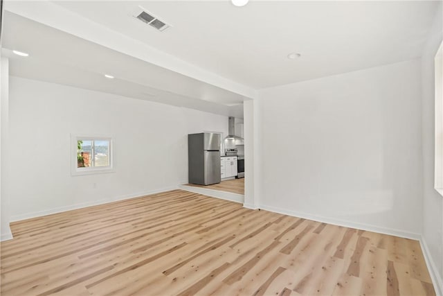 empty room with light hardwood / wood-style flooring