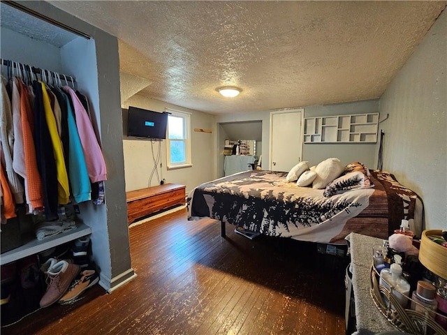 bedroom featuring dark hardwood / wood-style floors and a textured ceiling