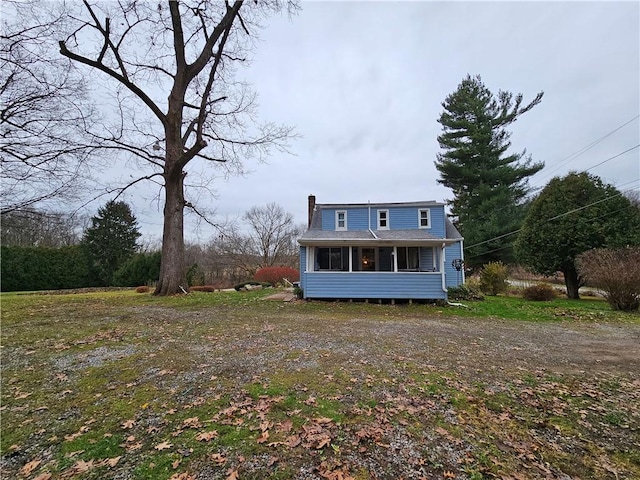 view of front of house featuring a sunroom