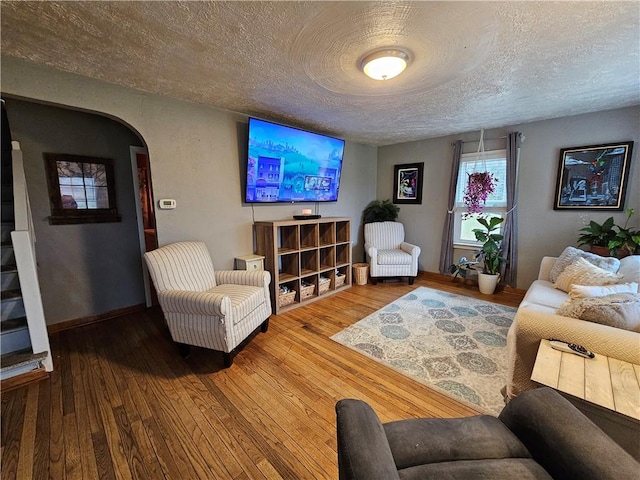 living room featuring a textured ceiling and hardwood / wood-style flooring