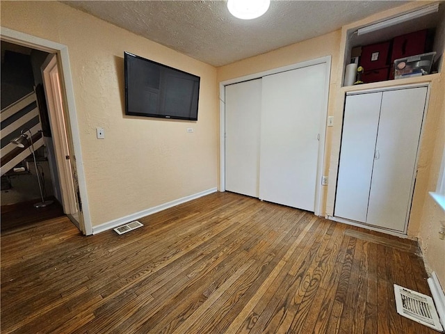 unfurnished bedroom with wood-type flooring and a textured ceiling