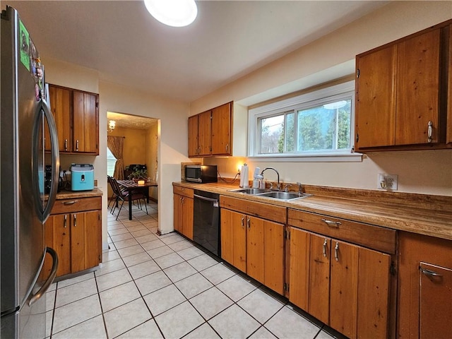 kitchen with light tile patterned flooring, sink, and stainless steel appliances