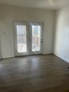 unfurnished room featuring dark hardwood / wood-style floors and french doors