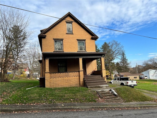 view of front property with covered porch and a front yard