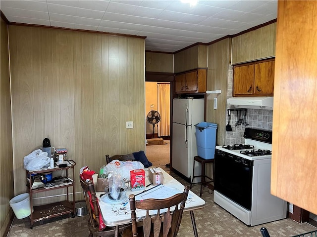 kitchen featuring wood walls and white appliances