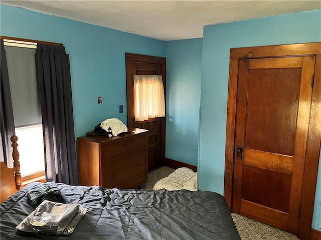 bedroom featuring light colored carpet