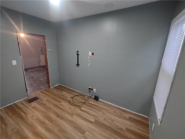 laundry room with hardwood / wood-style floors