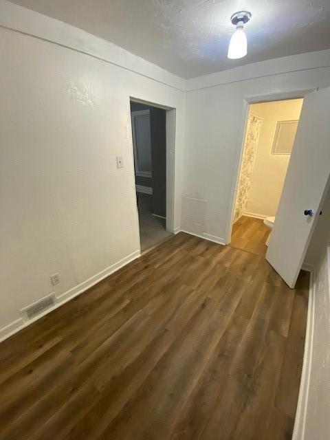 spare room featuring dark hardwood / wood-style floors