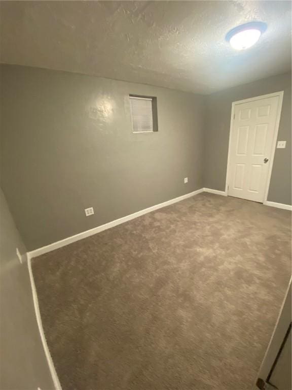 basement with carpet and a textured ceiling