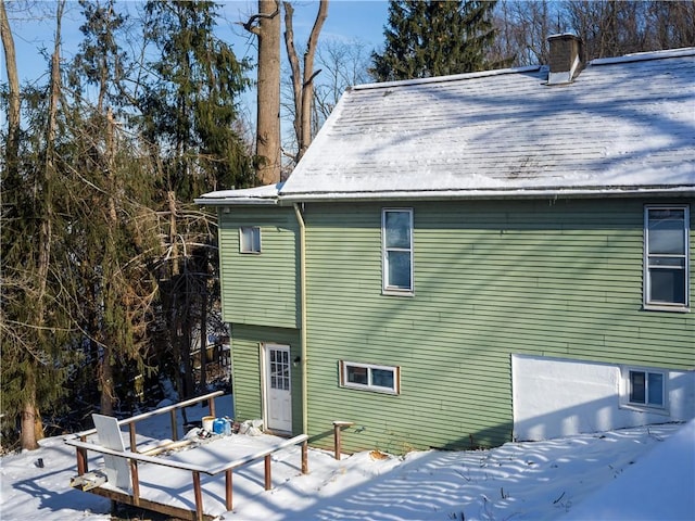 view of snow covered rear of property